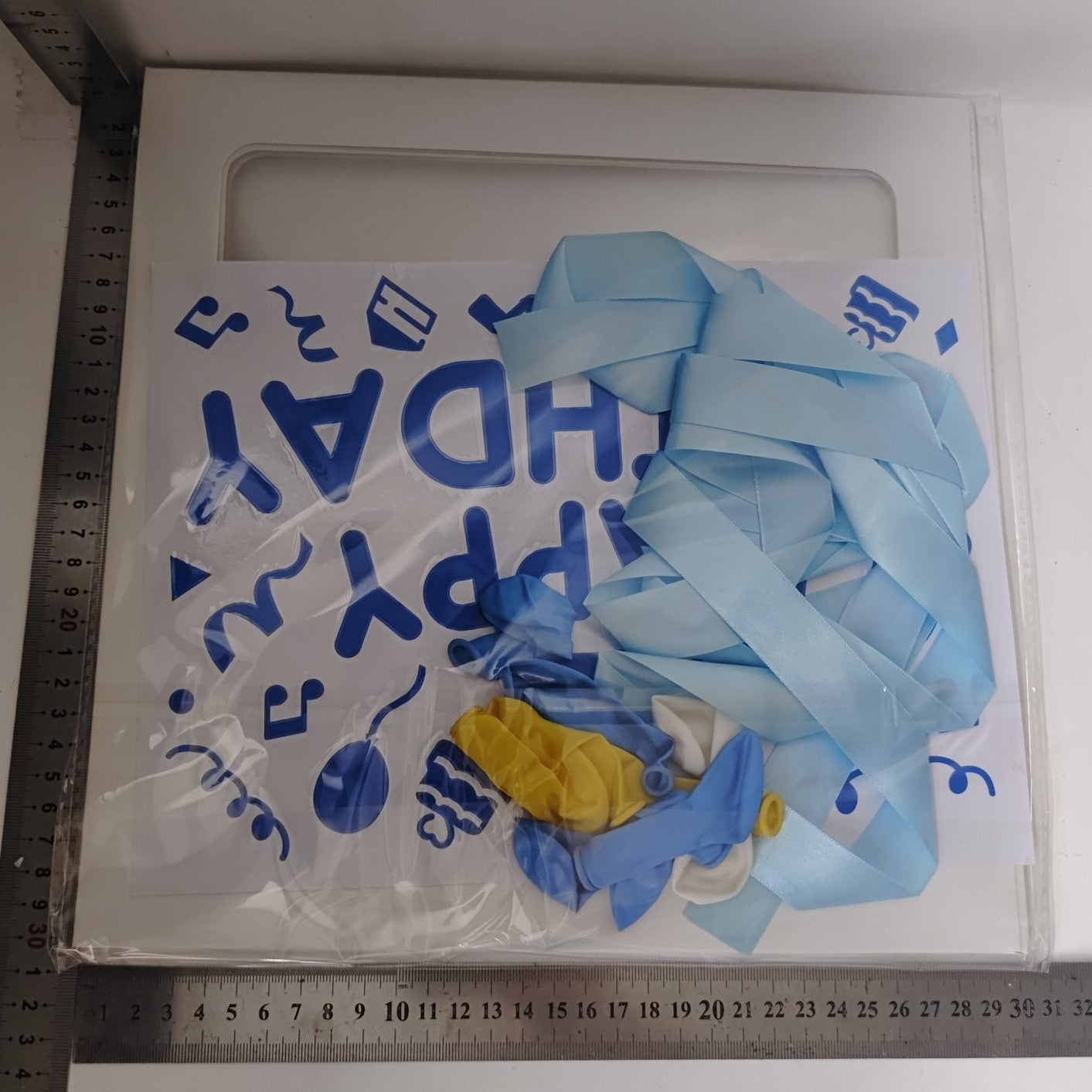 Cutie pentru Baloane, Tematica Aniversare, Model Scris Happy Birthday, Baloane Albastre, Albe, Galbene si Panglica Incluse, Contur Alb, Transparenta, 30x30 cm