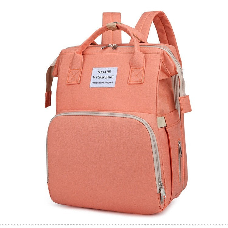 Rucsac Multifunctional pentru Mamici, cu Patut Pliabil si Baza de Schimbat, Rezistent la Apa, Capacitate Mare, Usor, Compartimente Multiple, Buzunar Termic pentru Lapte, 42 x 32 x 22 cm, Roz Pudra